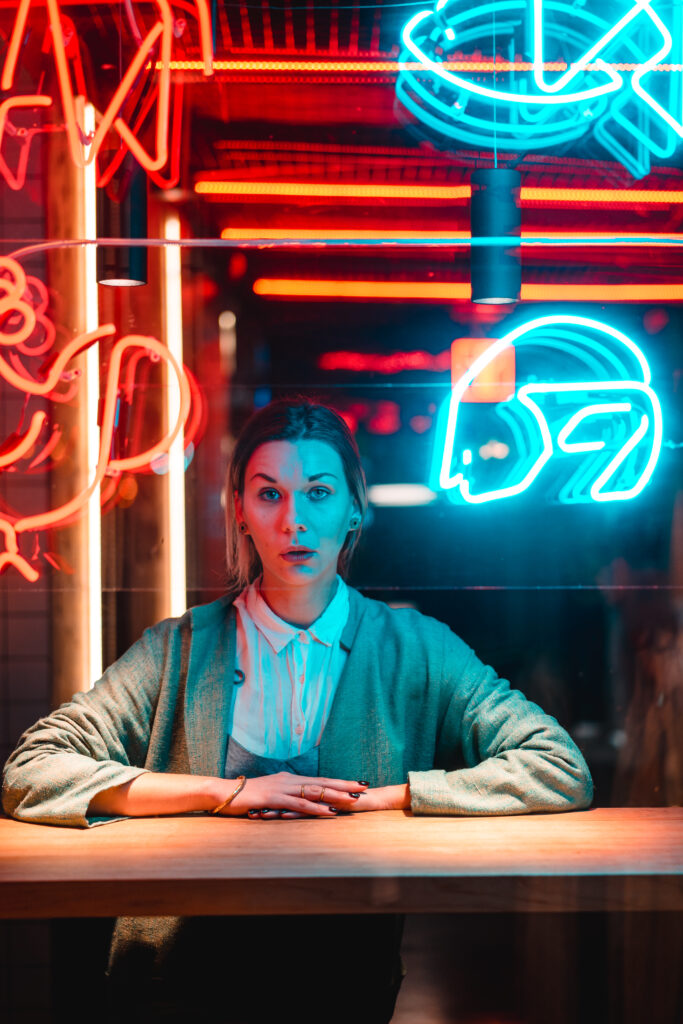 Beautiful girl in a window cafe and looks at the camera